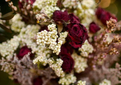 Arrangement with dried burgundy roses