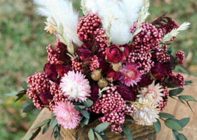 Arrangement with dried burgundy roses