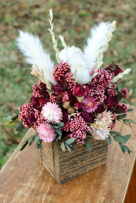 Arrangement with dried burgundy roses